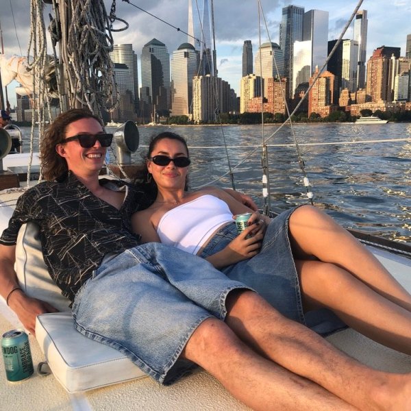 a group of people sitting next to a body of water