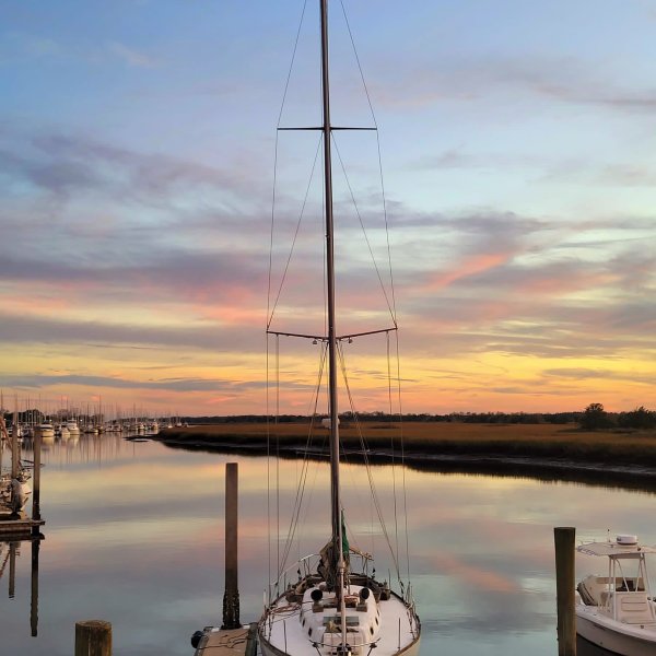 a boat is docked next to a body of water
