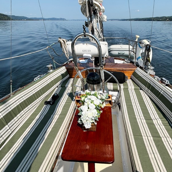a wooden boat is tied to a dock in a body of water